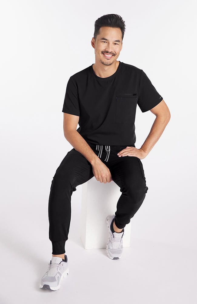 Man wearing Andre 8-Pocket Men's CORE Scrub Jogger Pant-Black-DOLAN