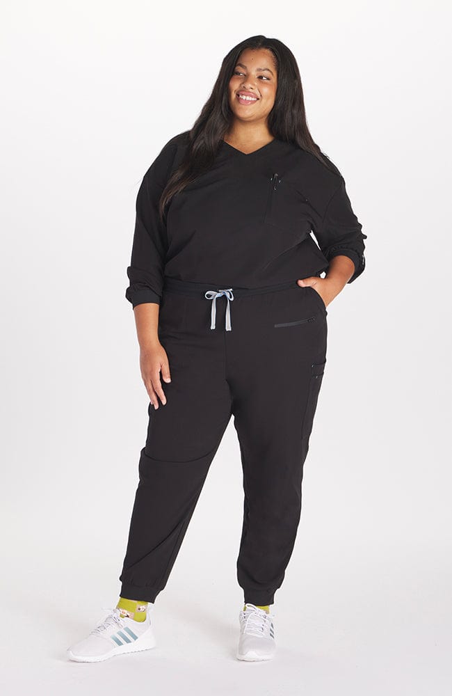 Woman in high waisted Hope 11 Pocket Jogger scrub pant in Black